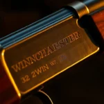 Detailed shot of a classic Winchester rifle showing the .32WIN cartridge, emphasizing precision and craftsmanship for firearm enthusiasts.